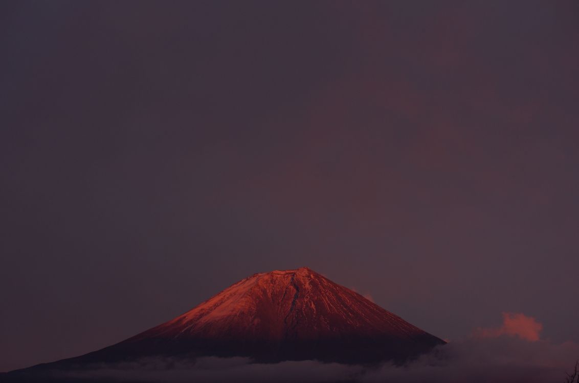 brown mountain under gray sky