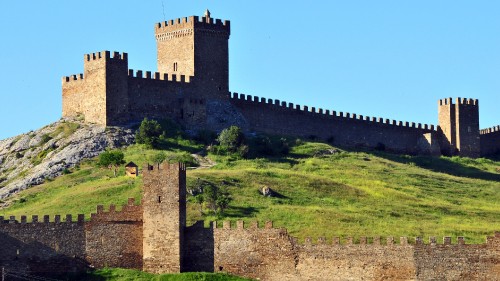 Image gray concrete castle under blue sky during daytime