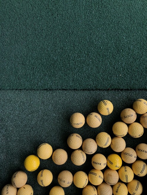 Image white golf balls on green textile