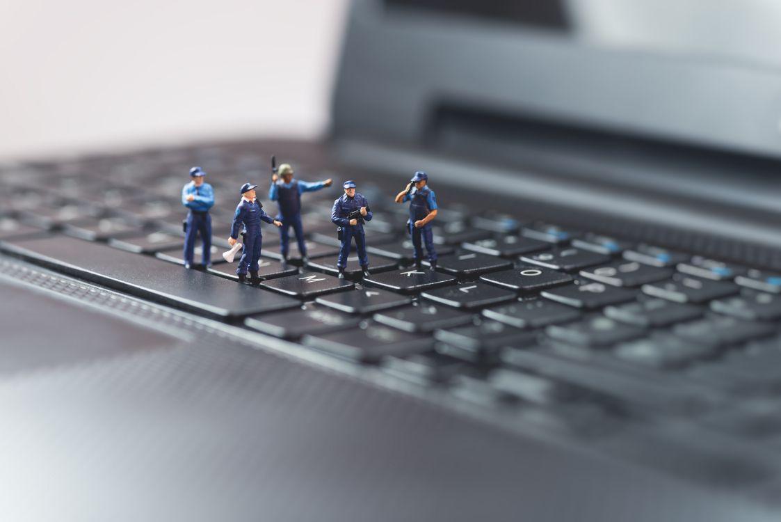 three lego toys on black computer keyboard