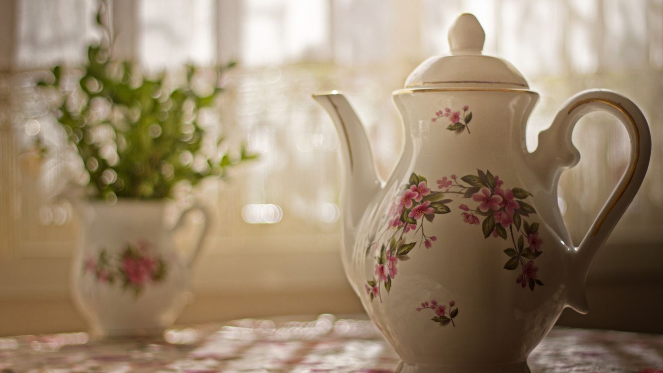 white and pink floral ceramic teapot