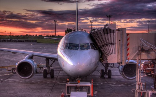 Image white airplane on airport during sunset