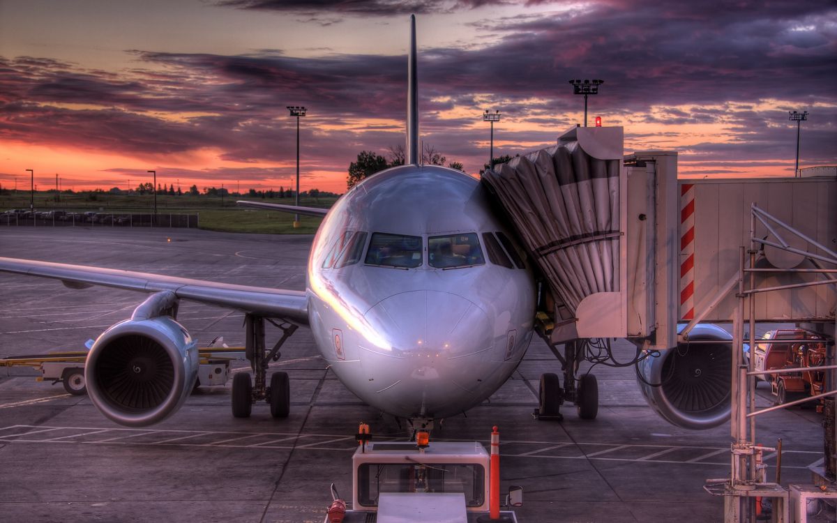 white airplane on airport during sunset