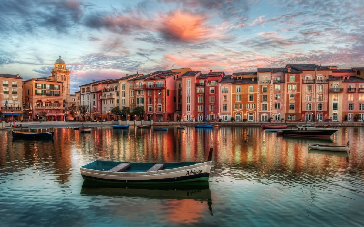 blue and white boat on water near building during daytime