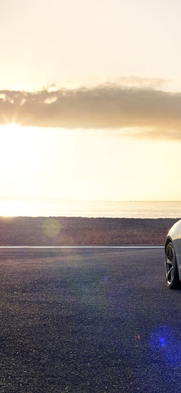 Image white porsche 911 on beach during sunset