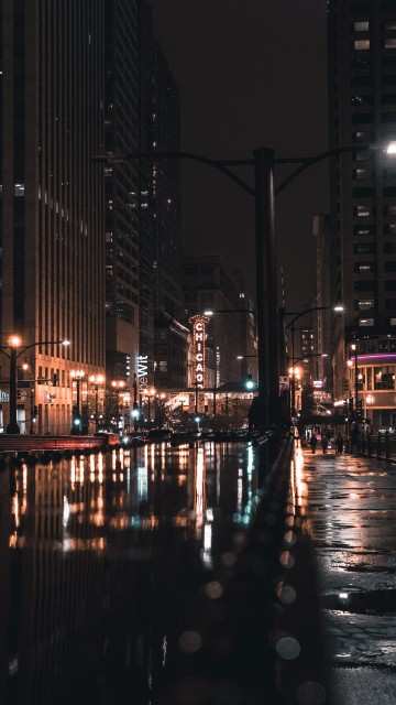 Image people walking on sidewalk during night time