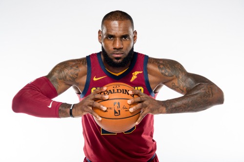 Image man in red and blue nike tank top holding basketball