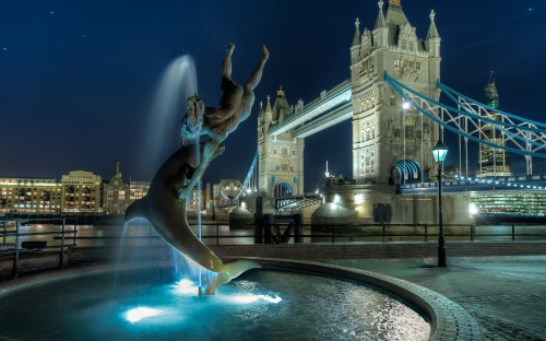 Image fountain in front of white concrete building during night time