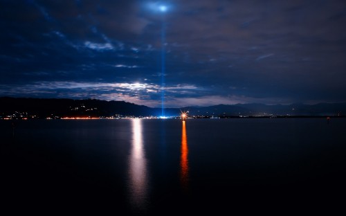 Image body of water under cloudy sky during night time