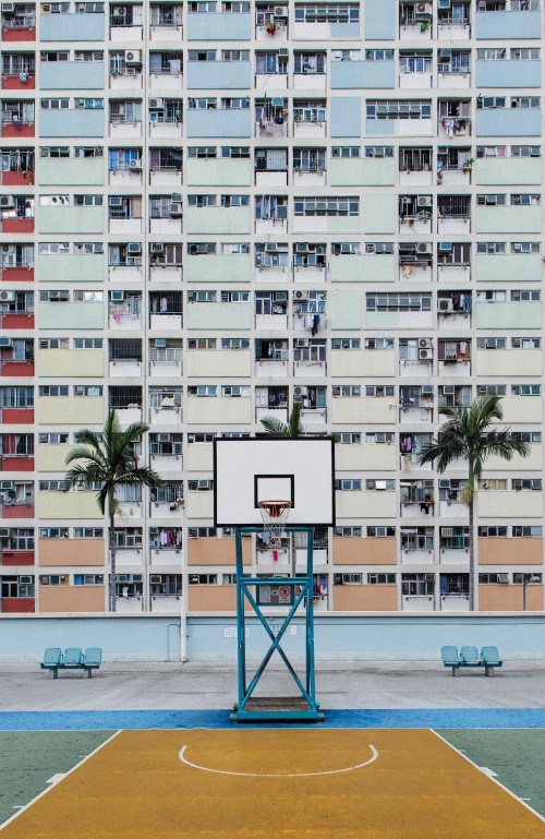 Image white and pink concrete building near beach during daytime