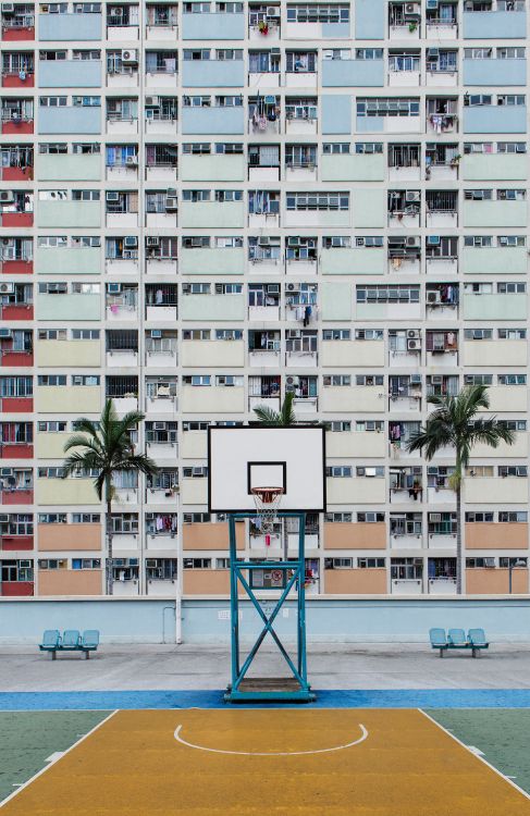 white and pink concrete building near beach during daytime