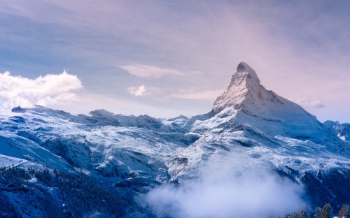 Image snow covered mountain under cloudy sky during daytime