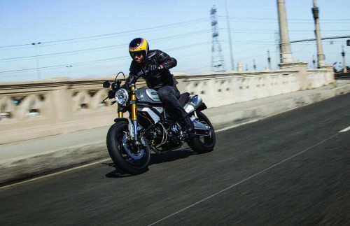 Image man in black helmet riding motorcycle on road during daytime