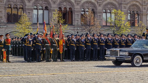 Image group of men in black and yellow uniform standing on gray concrete floor during daytime