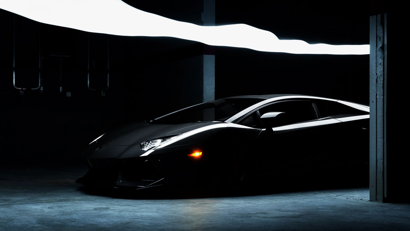 black lamborghini aventador in a dark room