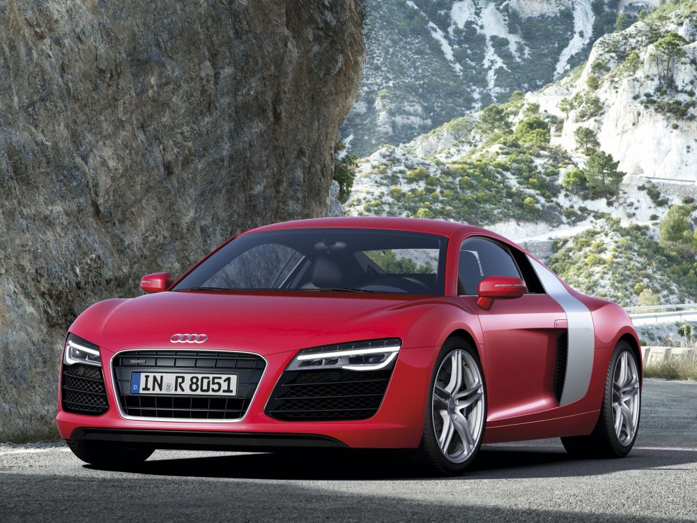 red audi r 8 parked on rocky mountain during daytime