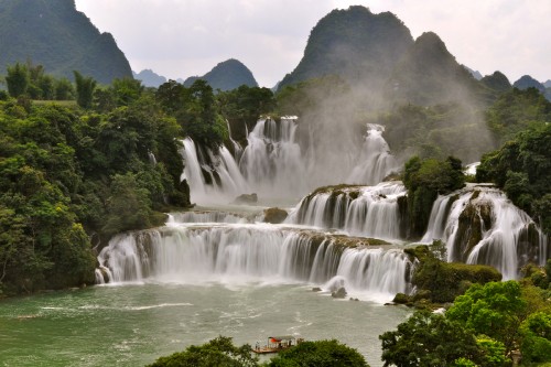 Image waterfalls near green trees during daytime