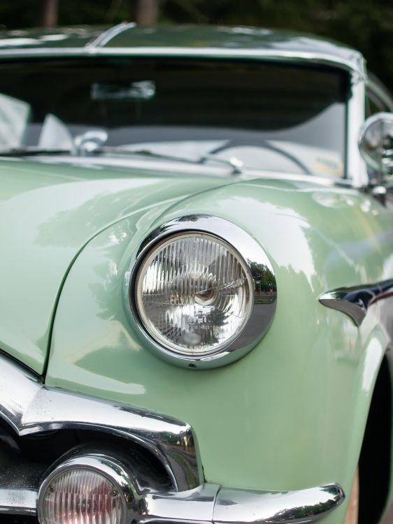 green car with chrome headlight