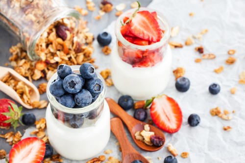 Image white cream with red and blue berries on top