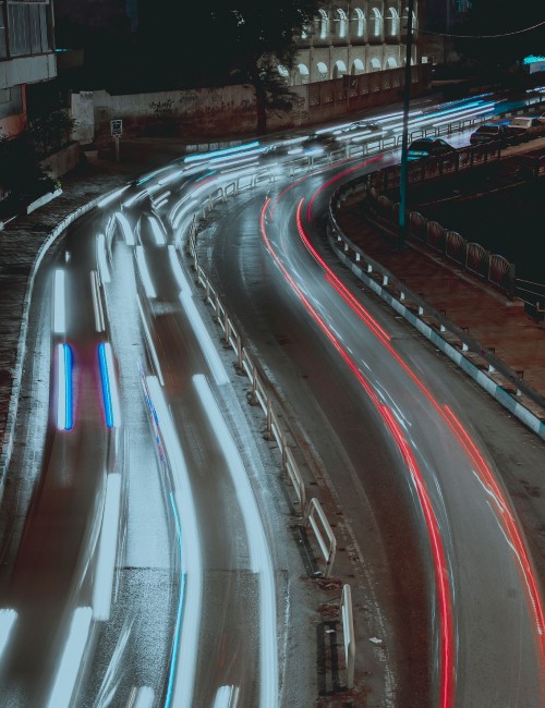 Image time lapse photography of cars on road during night time