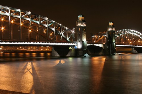 Image lighted bridge over water during night time