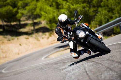 Image man in black and white motorcycle suit riding motorcycle on road during daytime