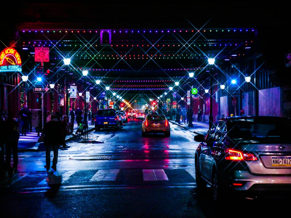 people walking on street during night time