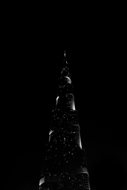 Image black tower with lights during night time