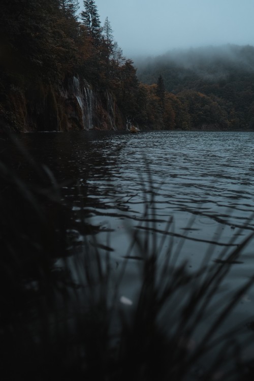 Image body of water near mountain during daytime