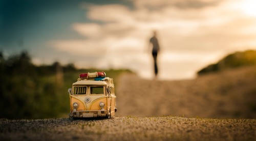 Image brown and white volkswagen t-2 van on brown field during daytime