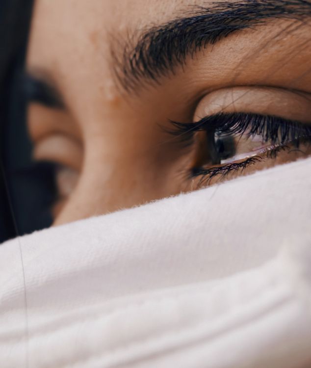 woman covering her face with white textile