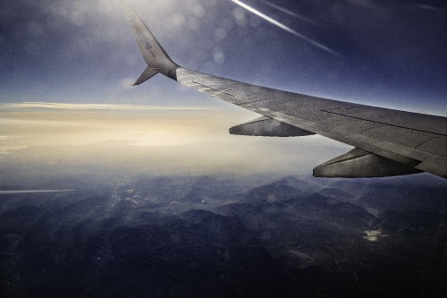 Image airplane wing over white clouds during daytime