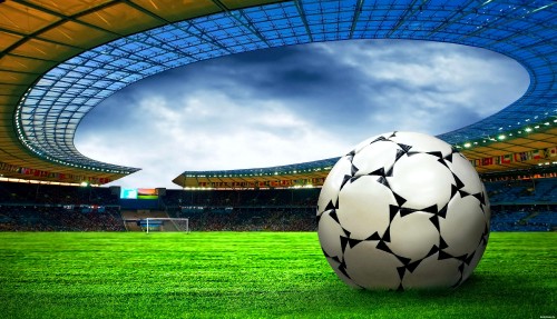 Image soccer ball on green grass field under white clouds during daytime