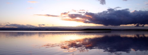 Image body of water under cloudy sky during daytime