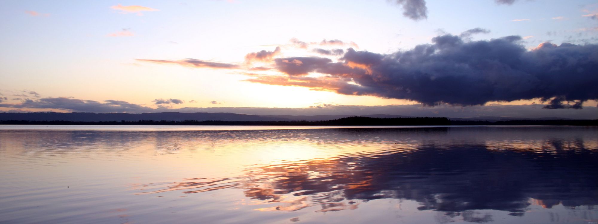 body of water under cloudy sky during daytime