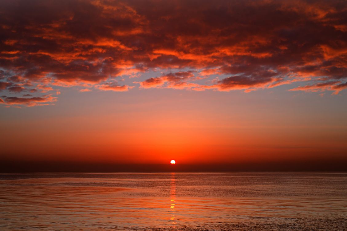 body of water during sunset