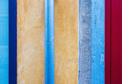 Image blue metal rod on brown concrete wall