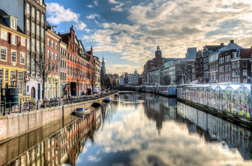 Image body of water between buildings under blue sky during daytime