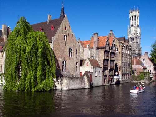 Image brown concrete building beside river during daytime