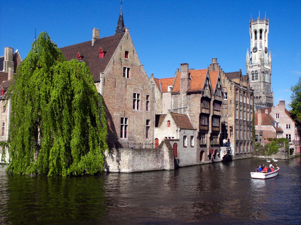 brown concrete building beside river during daytime