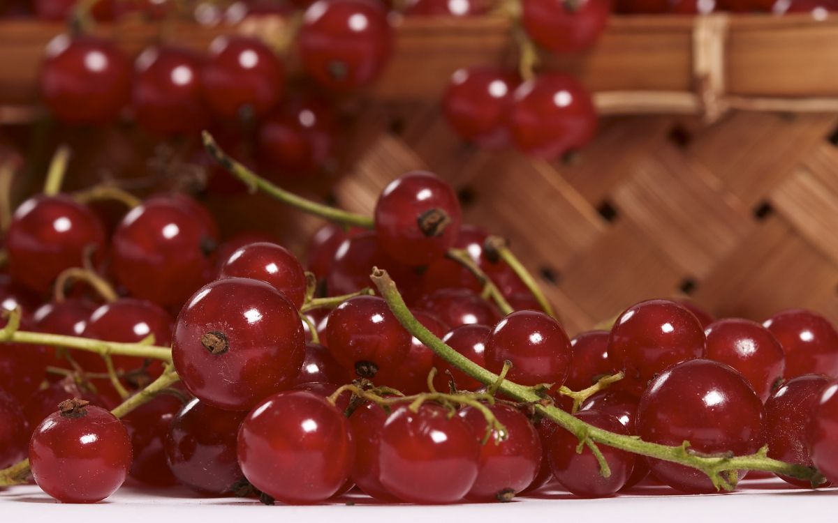 red cherries on brown wooden table