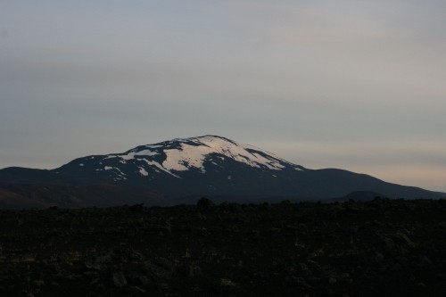 Image snow covered mountain under cloudy sky during daytime