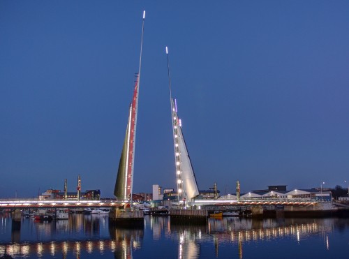 Image white bridge over body of water during night time