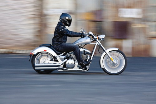 Image man in black helmet riding on white and black motorcycle