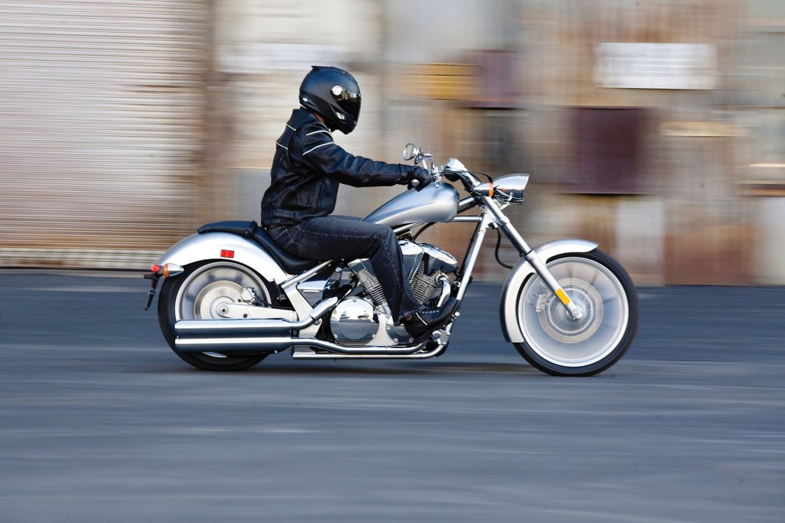 man in black helmet riding on white and black motorcycle