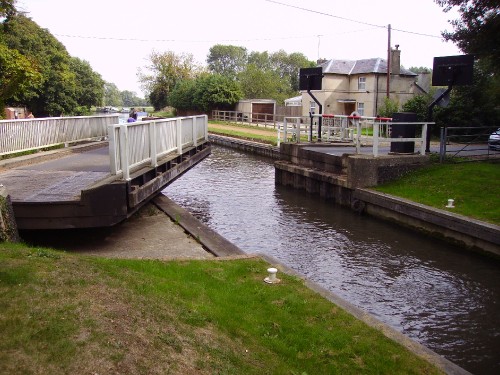 Image white and brown concrete building beside river during daytime