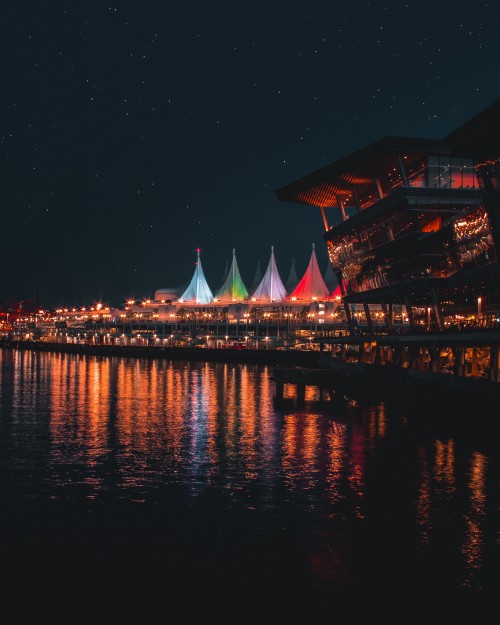 Image brown and white building near body of water during night time