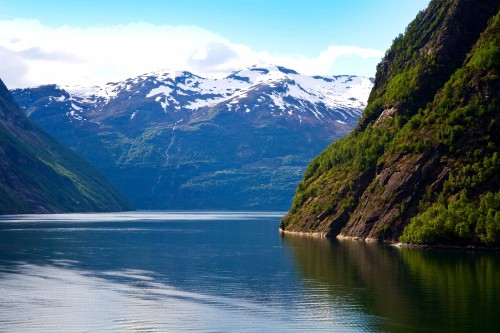 Image body of water near mountain during daytime