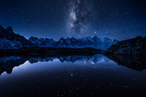 Image snow covered mountain during night time