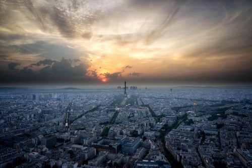 Image city buildings under white clouds during sunset